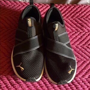 Puma Black Slip-On Trainers with Gold Logo Accents